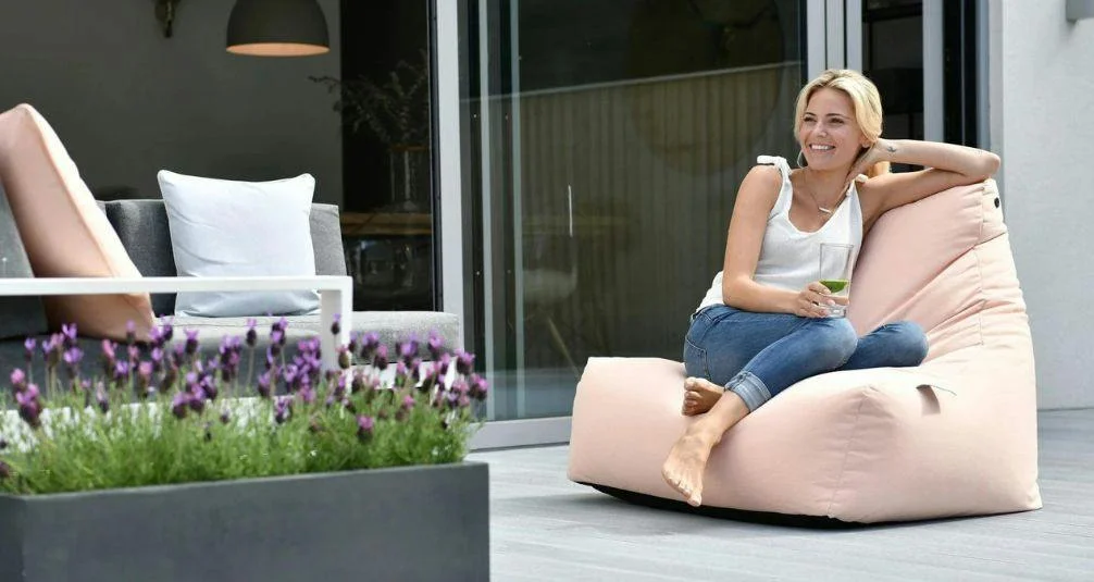 Woman sitting on pastel coloured beanbag