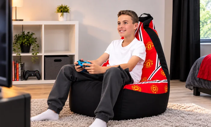 Manchester United football gaming bean bag chair in a bedroom