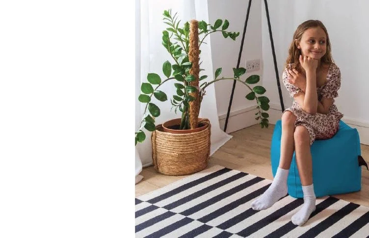 Girl Sitting on Small Footstool Beanbag
